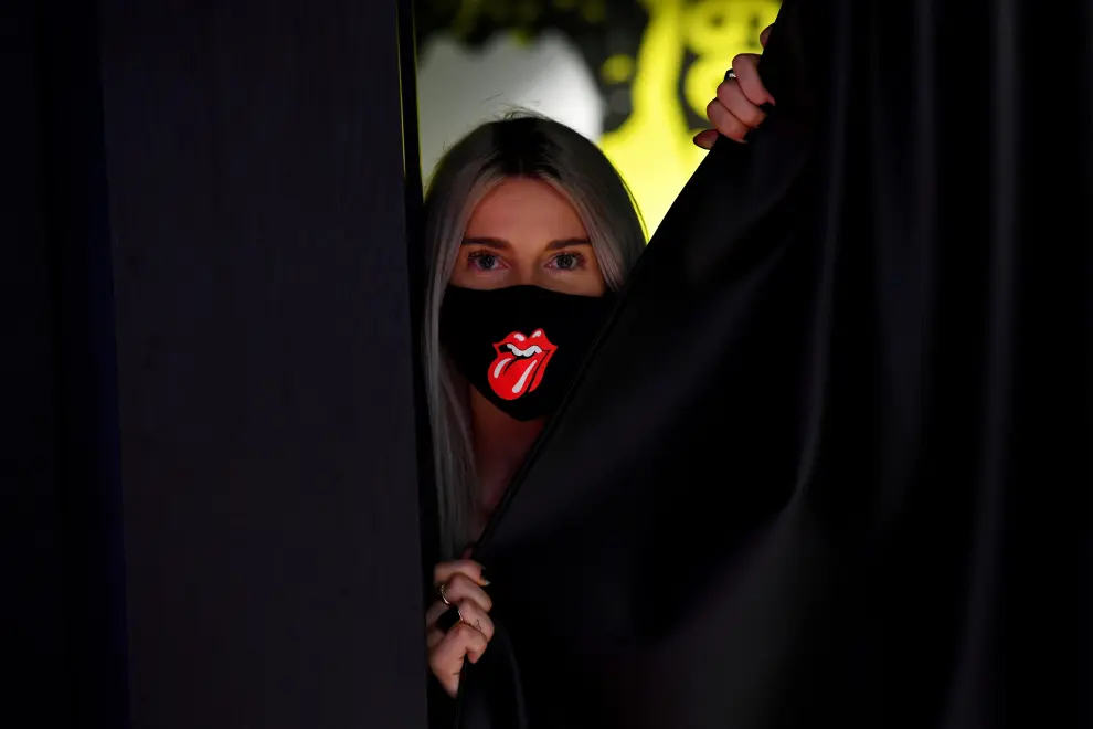 A shop assistant wearing a face mask is seen at the new flagship Rolling Stones store named 'RS No. 9 Carnaby' in London, Britain, September 8, 2020. REUTERS/Dylan Martinez [[[REUTERS VOCENTO]]] MUSIC-ROLLING STONES/BRITAIN-STORE