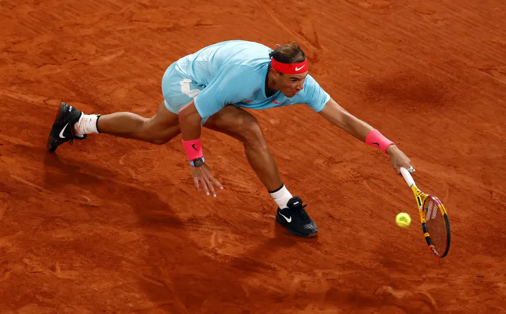 11 October 2020, France, Paris: Spanish tennis player Rafael Nadal returns the ball to Serbia's Novak Djokovic during their men's singles final tennis match of the Roland Garros 2020 French Open tennis tournament, at the Philippe Chatrier court. Photo: Anne-Christine Poujoulat/AFP/dpa11/10/2020 ONLY FOR USE IN SPAIN [[[EP]]] 11 October 2020, France, Paris: Spanish tennis player Rafael Nadal returns the ball to Serbia's Novak Djokovic during their men's singles final tennis match of the Roland Garros 2020 French Open tennis tournament, at the Philippe Chatrier court. Photo: An