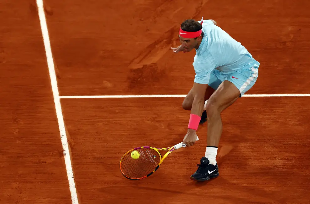 11 October 2020, France, Paris: Spanish tennis player Rafael Nadal returns the ball to Serbia's Novak Djokovic during their men's singles final tennis match of the Roland Garros 2020 French Open tennis tournament, at the Philippe Chatrier court. Photo: Anne-Christine Poujoulat/AFP/dpa11/10/2020 ONLY FOR USE IN SPAIN [[[EP]]] 11 October 2020, France, Paris: Spanish tennis player Rafael Nadal returns the ball to Serbia's Novak Djokovic during their men's singles final tennis match of the Roland Garros 2020 French Open tennis tournament, at the Philippe Chatrier court. Photo: An
