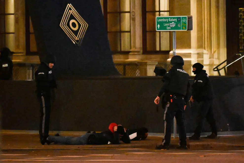 Vienna (Austria), 01/11/2020.- Austrian police men search two civilian infront of The Wiener Staatsoper (Vienna State Opera) after a shooting near the 'Stadttempel' synagogue in Vienna, Austria, 02 November 2020. According to recent reports, at least one person is reported to have died and three are injured in what officials treat as a terror attack. (Atentado, Viena) EFE/EPA/CHRISTIAN BRUNA Vienna terror attack