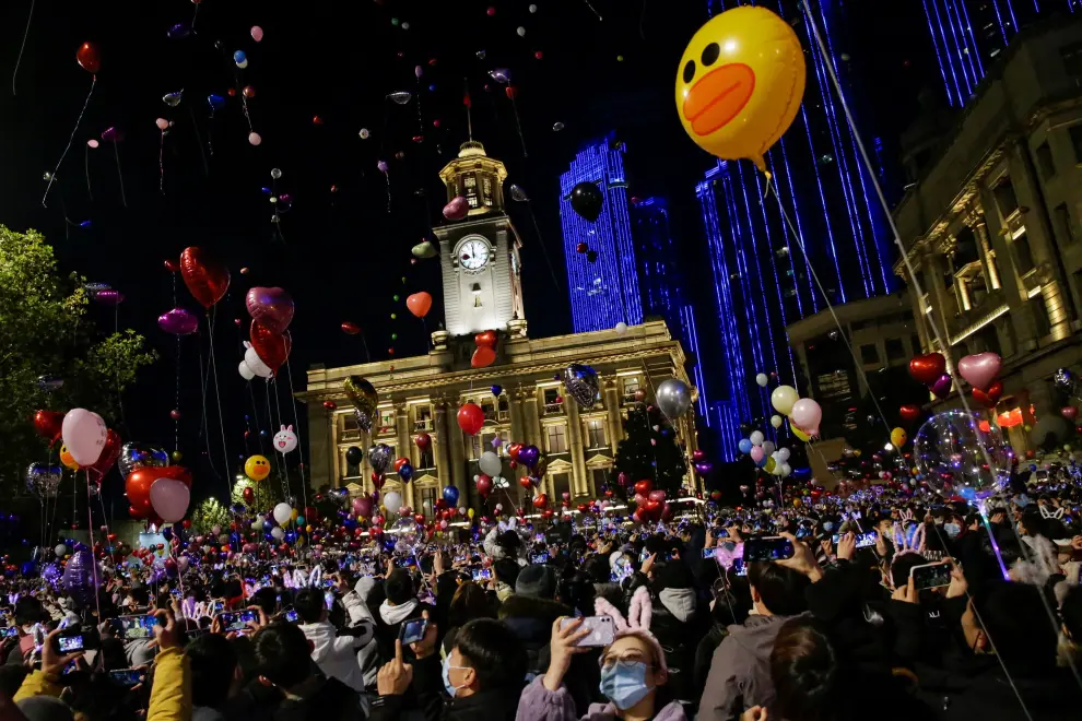 People hold balloons as they gather to celebrate the arrival of the new year during the coronavirus disease (COVID-19) outbreak in Wuhan, China December 31, 2020. REUTERS/Tingshu Wang[[[REUTERS VOCENTO]]] HEALTH-CORONAVIRUS/NEWYEAR-WUHAN