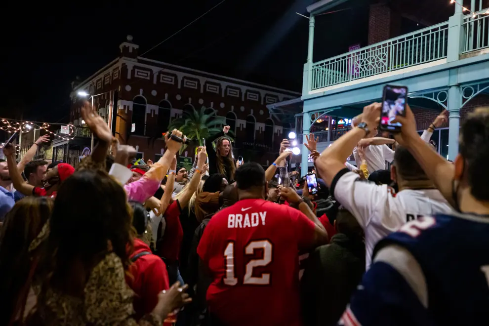 Feb 7, 2021; Tampa, Florida, USA;  Residents of Tampa celebrate a Buccaneers touchdown at a massive block party beside Raymond James Stadium during Super Bowl LV between the Kansas City Chiefs and the Tampa Bay Buccaneers in Tampa, FL.  Mandatory Credit: Mary Holt-USA TODAY Sports[[[REUTERS VOCENTO]]] FOOTBALL-NFL/