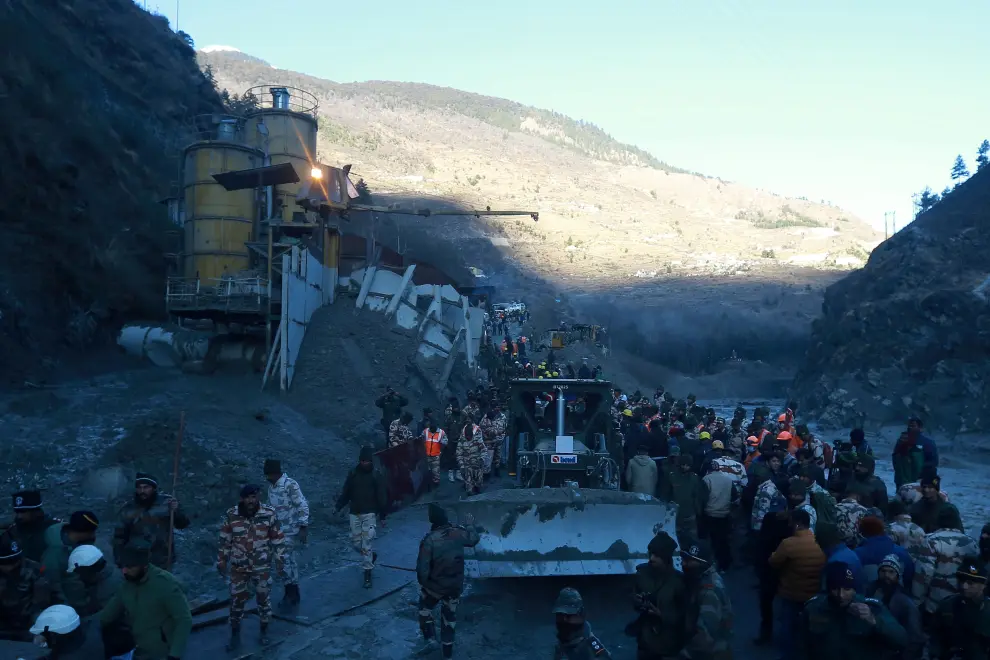 Members of Indo-Tibetan Border Police and Army soldiers with their machines work to clear a tunnel after a part of a glacier broke away, in Tapovan