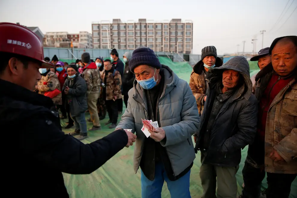 The Wider Image: 'I've let them down': Beijing's migrant workers miss family reunions on Lunar New Year