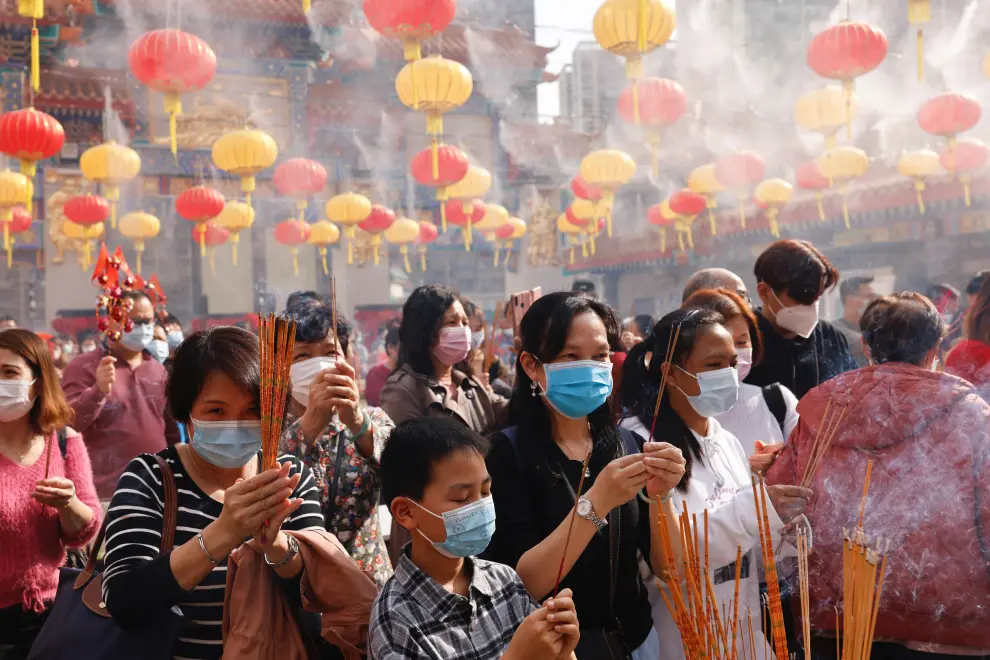Worshippers wearing face masks make offerings of incense sticks during the first day of Chinese Lunar New Year, following the coronavirus disease (COVID-19) outbreak, at Wong Tai Sin Temple, in Hong Kong
