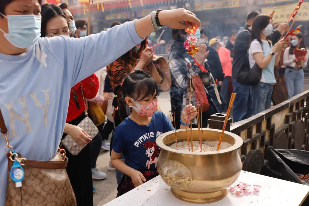 Worshippers wearing face masks make offerings of incense sticks during the first day of Chinese Lunar New Year, following the coronavirus disease (COVID-19) outbreak, at Wong Tai Sin Temple, in Hong Kong