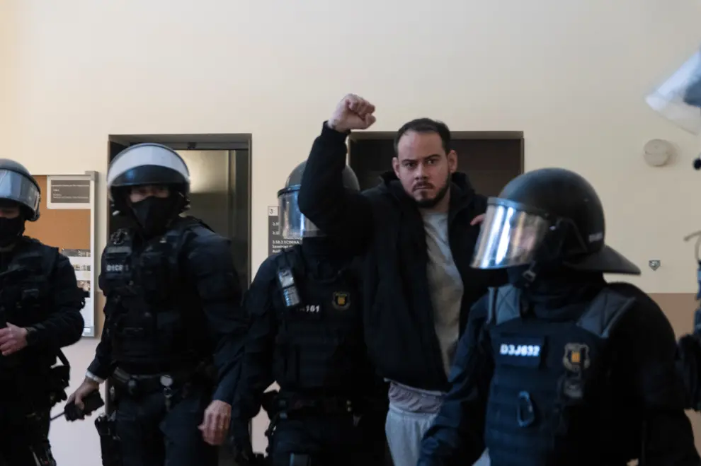 Spanish rapper Pablo Hasel reacts as he is detained by riot police inside the University of Lleida, after he was sentenced to jail time on charges including insulting the monarchy and glorifying terrorism, in Lleida, Spain February 16, 2021. REUTERS/Lorena Sopena[[[REUTERS VOCENTO]]] SPAIN-RIGHTS/RAPPER-ARREST