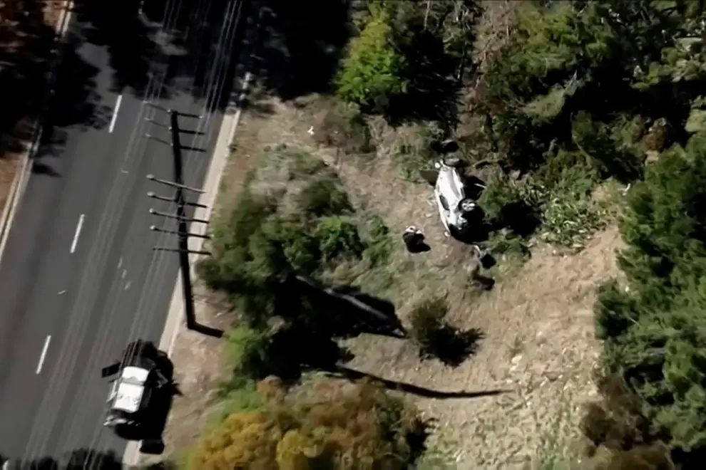 The vehicle of golfer Tiger Woods, who was rushed to hospital after suffering multiple injuries, lies on its side after being involved in a single-vehicle accident in Los Angeles, California, U.S. in a still image from video taken February 23, 2021. KNBC via REUTERS NO RESALES. NO ARCHIVES. MANDATORY CREDIT. THIS IMAGE HAS BEEN SUPPLIED BY A THIRD PARTY.[[[REUTERS VOCENTO]]] PEOPLE-WOODS/ACCIDENT