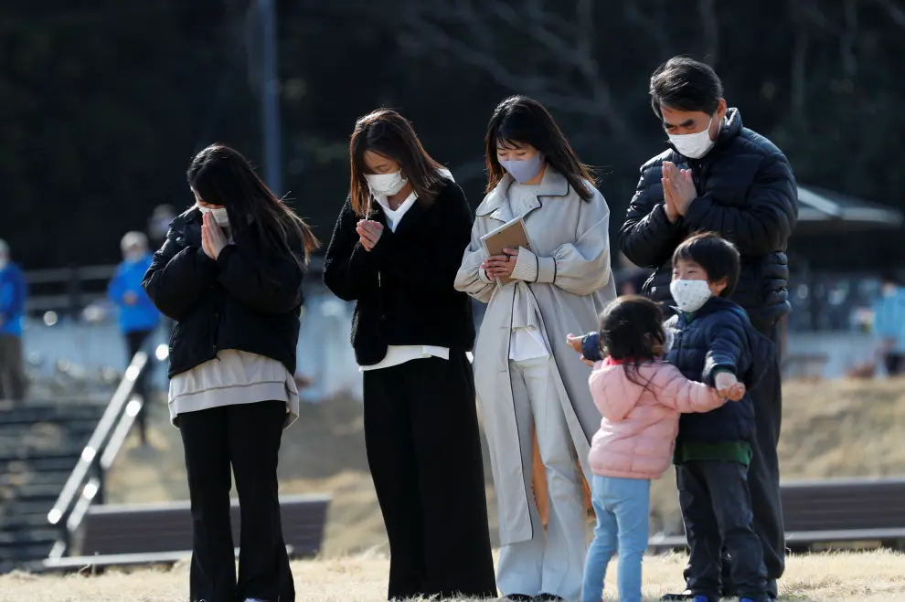 People observe a moment of silence at 2:46 p.m. (0546 GMT), the time when the 9.0-magnitude earthquake struck off Japan's coast in 2011, during a memorial service at Hibiya Park in Tokyo, Japan, March 11, 2021, to mark the ten-year anniversary of the earthquake and tsunami that killed thousands and set off a nuclear crisis. REUTERS/Issei Kato[[[REUTERS VOCENTO]]] JAPAN-FUKUSHIMA/ANNIVERSARY