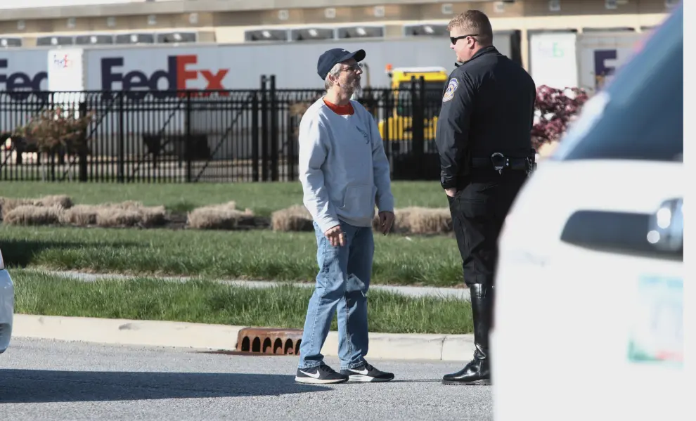 Police is seen at a street following a shooting incident at a FedEx facility in Indianapolis, Indiana, U.S. April 16, 2021, in this still image taken from a video. Kevin Powell/Indy First Alert/via REUTERS THIS IMAGE HAS BEEN SUPPLIED BY A THIRD PARTY. MANDATORY CREDIT.[[[REUTERS VOCENTO]]] INDIANA-SHOOTING/
