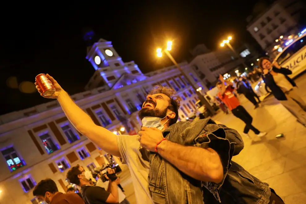 People celebrate as the state of emergency decreed by the Spanish Government to prevent the spread of the coronavirus disease (COVID-19) gets lifted in Madrid