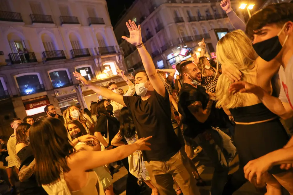People celebrate as the state of emergency decreed by the Spanish Government to prevent the spread of the coronavirus disease (COVID-19) gets lifted in Madrid