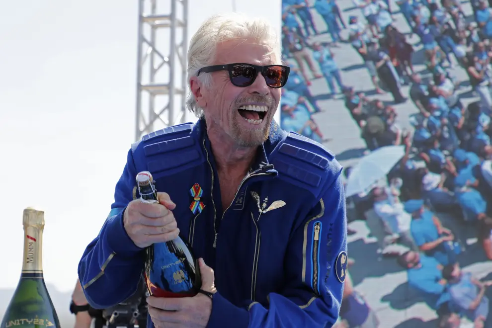 Billionaire entrepreneur Richard Branson prepares to spray champagne at Spaceport America