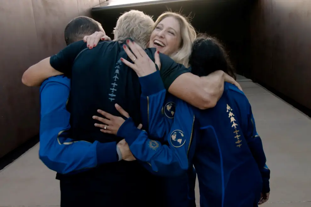 Virgin Galactic's chief astronaut instructor Beth Moses embraces Richard Branson at Spaceport America