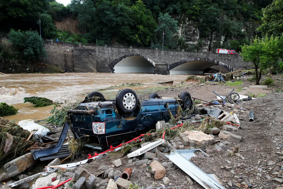 A man and firefighter walk through debris, following heavy rainfalls in Schuld, Germany, July 15, 2021. REUTERS/Wolfgang Rattay[[[REUTERS VOCENTO]]] EUROPE-WEATHER/GERMANY