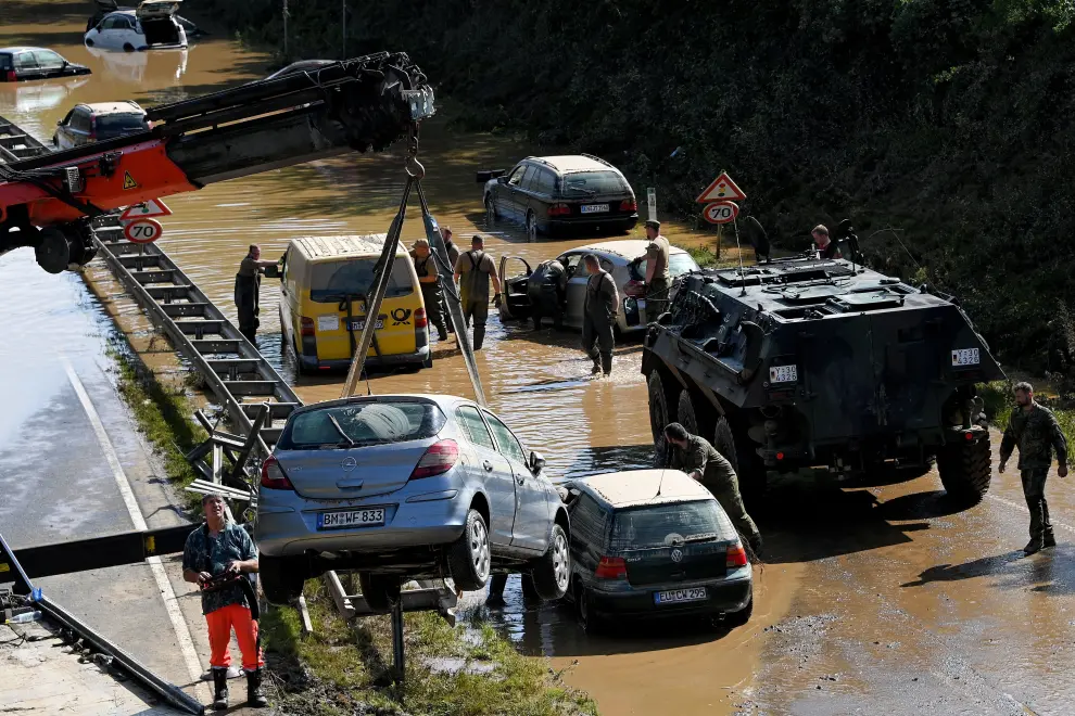 Erftstadt (Germany), 17/07/2021.- Rescue services clear wrecked cars and trucks from the B265 federal highway in Erftstadt, Germany, 17 July 2021. Large parts arts of central Eruope were hit by heavy, continuous rain resulting in local flash floods that destroyed buildings and swept away cars. At least 140 people died in Germany. (Inundaciones, Alemania) EFE/EPA/SASCHA STEINBACH Floodings in Germany