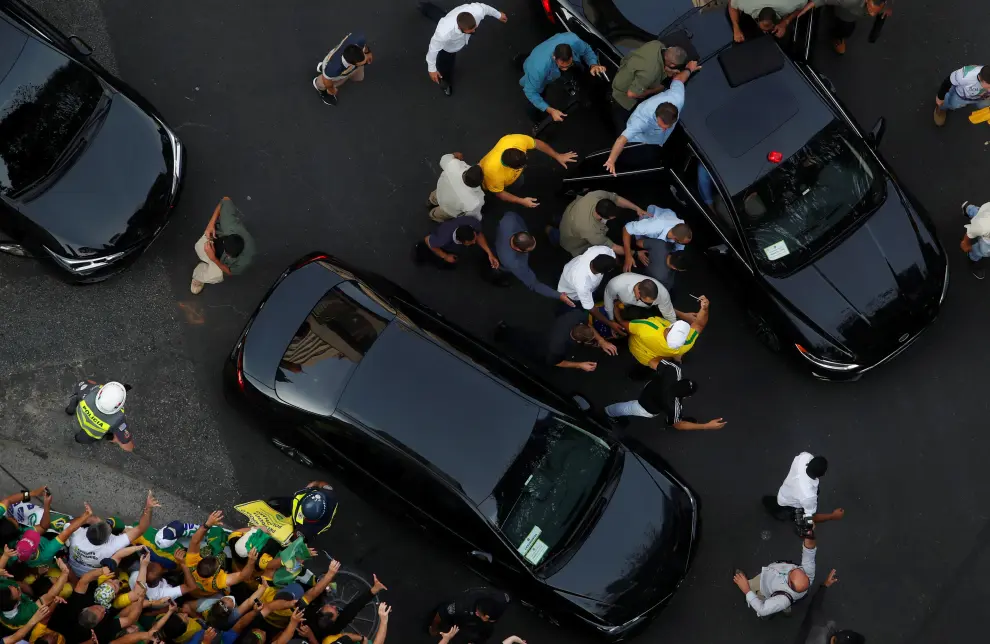 Brazilian President Jair Bolsonaro boards a car as his supporters gather to back the far-right leader in his dispute with the Supreme Court, in Sao Paulo