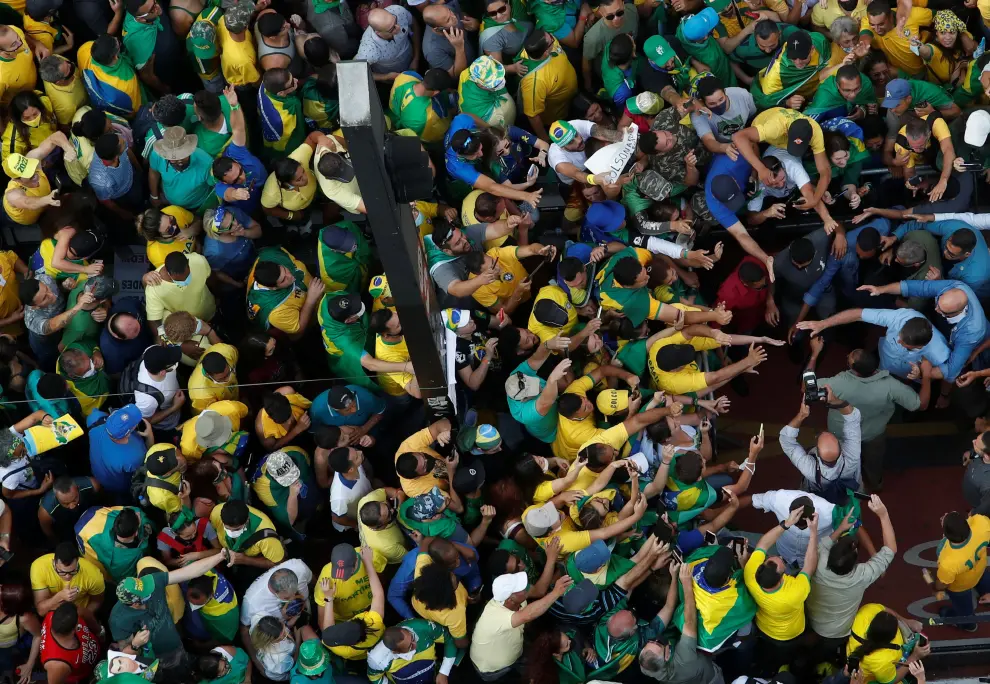 Brazilian President Jair Bolsonaro greets his supporters as they gather to back the far-right leader in his dispute with the Supreme Court, in Sao Paulo