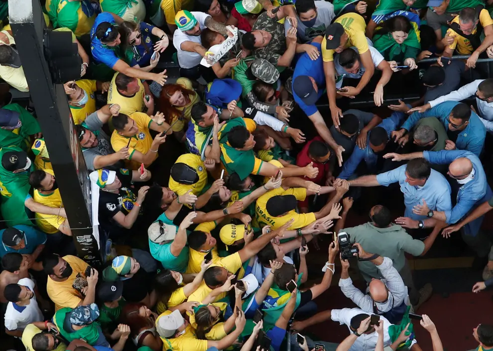 Brazilian President Jair Bolsonaro greets his supporters as they gather to back the far-right leader in his dispute with the Supreme Court, in Sao Paulo