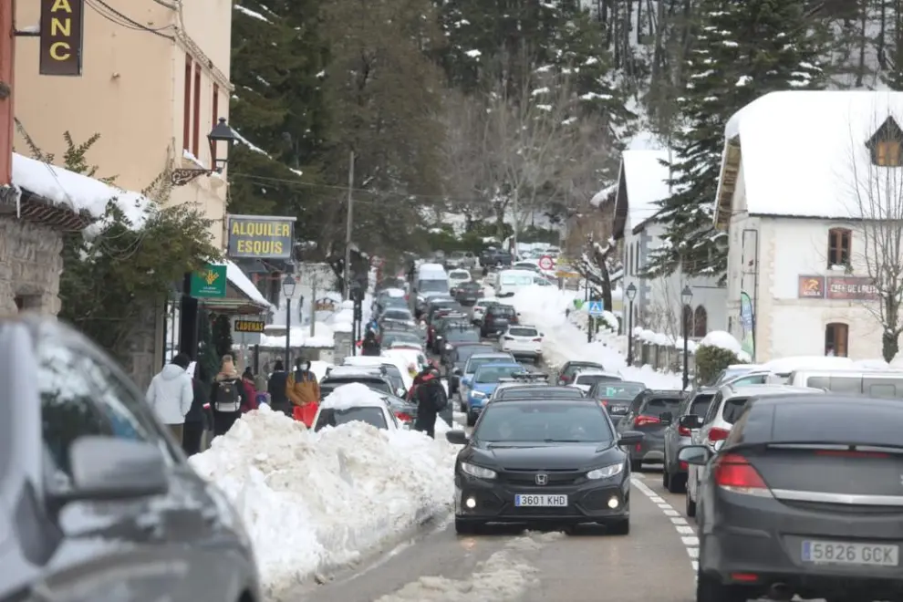 Tráfico denso por la nieve en Canfranc, el mediodía de este lunes.