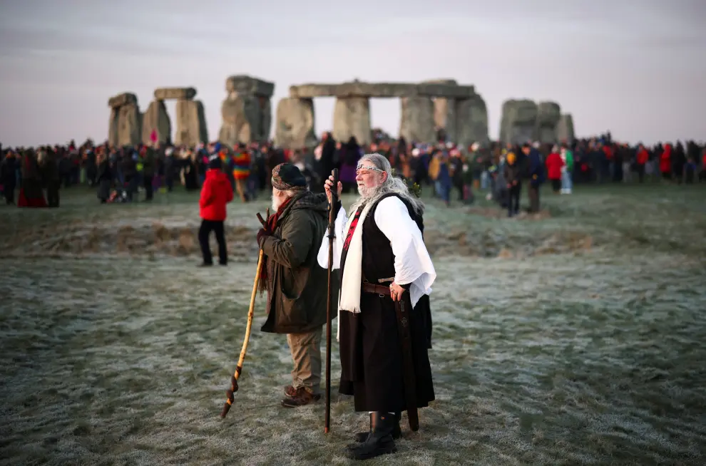 Revellers gather at the Stonehenge stone circle as they welcome in the winter solstice, as the sun rises in Amesbury, Britain, December 22, 2021. REUTERS/Henry Nicholls BRITAIN-SOLSTICE/