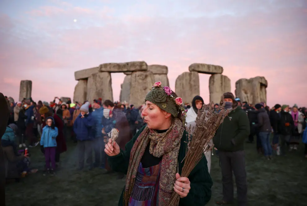 Druid Arthur Pendragon stands at the Stonehenge stone circle, as he welcomes in the winter solstice, as the sun rises in Amesbury, Britain, December 22, 2021. REUTERS/Henry Nicholls BRITAIN-SOLSTICE/
