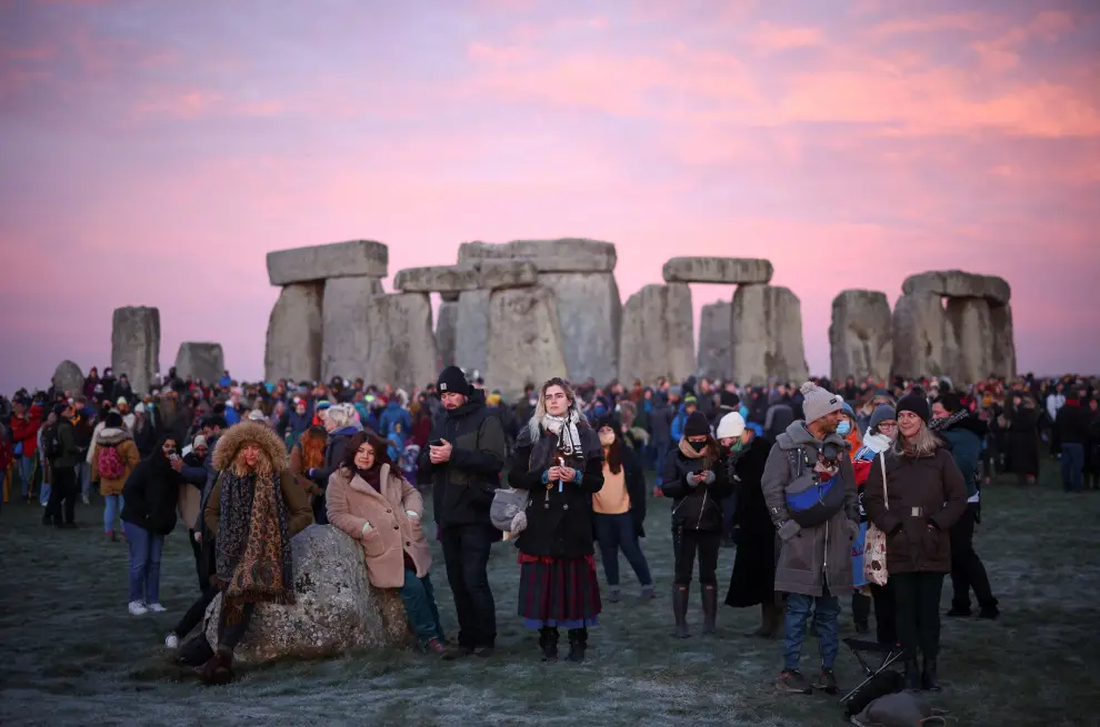 A reveller burns incense at the Stonehenge stone circle, as they welcome in the winter solstice, as the sun rises in Amesbury, Britain, December 22, 2021. REUTERS/Henry Nicholls BRITAIN-SOLSTICE/