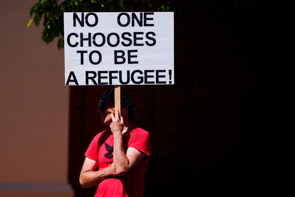 A pro-refugee protestor demonstrates in front of the Park Hotel, where Serbian tennis player Novak Djokovic is held after being placed in detention, in Melbourne, Australia, January 15, 2022. REUTERS/Sandra Sanders TENNIS-AUSTRALIA/DJOKOVIC