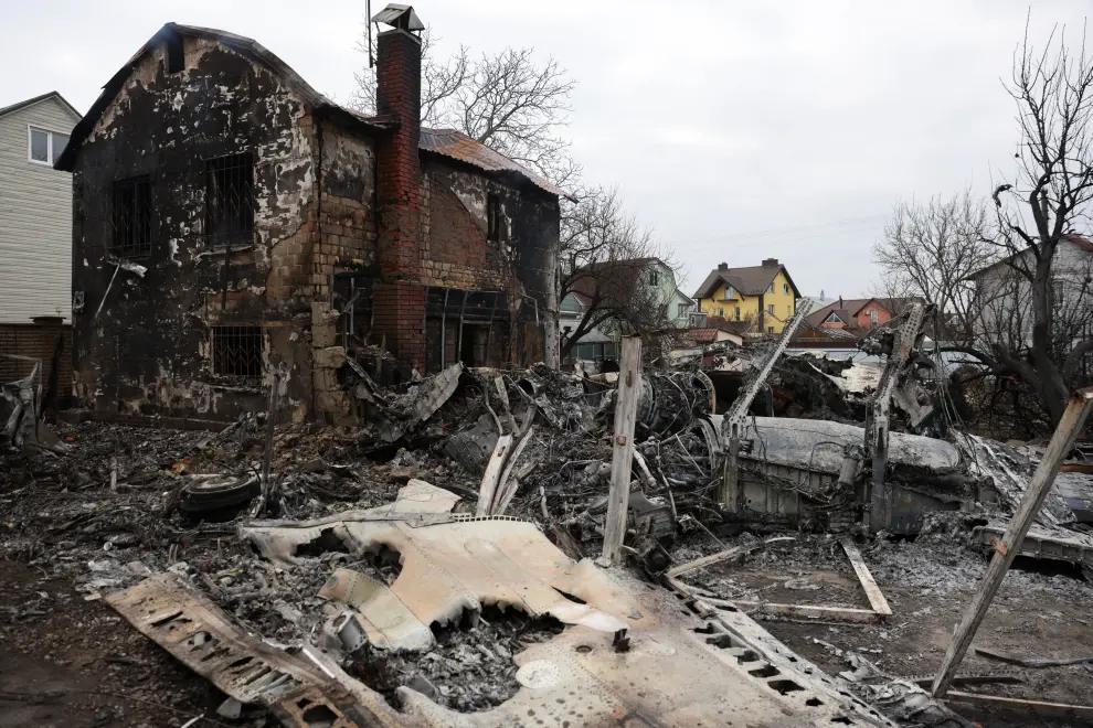 A person walks around the wreckage of an unidentified aircraft that crashed into a house in a residential area, after Russia launched a massive military operation against Ukraine, in Kyiv, Ukraine February 25, 2022. REUTERS/Umit Bektas UKRAINE-CRISIS/