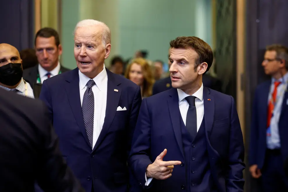 France's President Emmanuel Macron gestures as he talks to U.S. President Joe Biden during a NATO summit to discuss Russia's invasion of Ukraine, at the alliance's headquarters in Brussels, Belgium, March 24, 2022. REUTERS/Gonzalo Fuentes UKRAINE-CRISIS/NATO