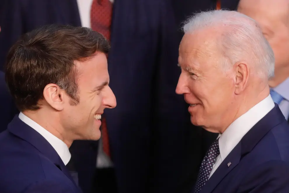 France's President Emmanuel Macron gestures next to U.S. President Joe Biden during a NATO summit to discuss Russia's invasion of Ukraine, at the alliance's headquarters in Brussels, Belgium, March 24, 2022. REUTERS/Gonzalo Fuentes UKRAINE-CRISIS/NATO