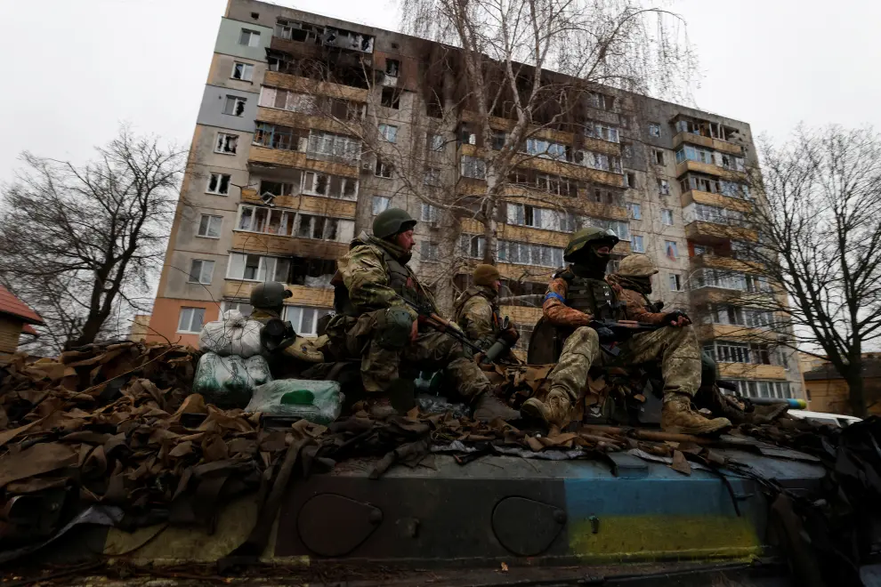 Ukrainian soldiers are pictured on their military vehicle, amid Russia's invasion on Ukraine in Bucha, in Kyiv region