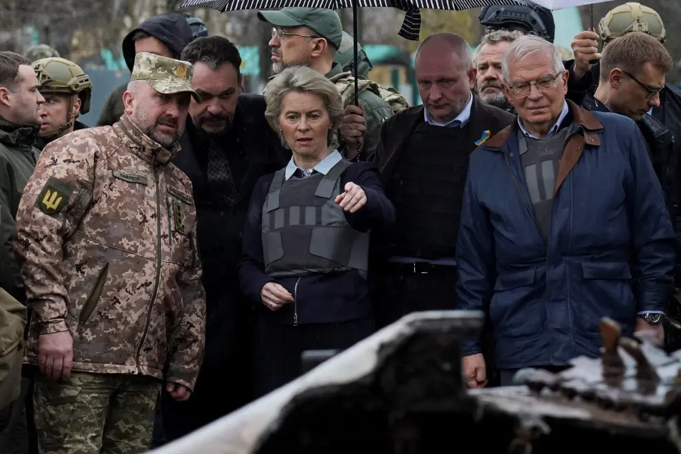 European Commission President Ursula von der Leyen, High Representative of the European Union for Foreign Affairs and Security Policy Josep Borrell and Slovakia's Prime Minister Eduard Heger stand next to bodies that were exhumed from a mass grave as they visit the town of Bucha, as Russia's attack on Ukraine continues, outside of Kyiv, Ukraine April 8, 2022. REUTERS/Valentyn Ogirenko UKRAINE-CRISIS/EU-BUCHA