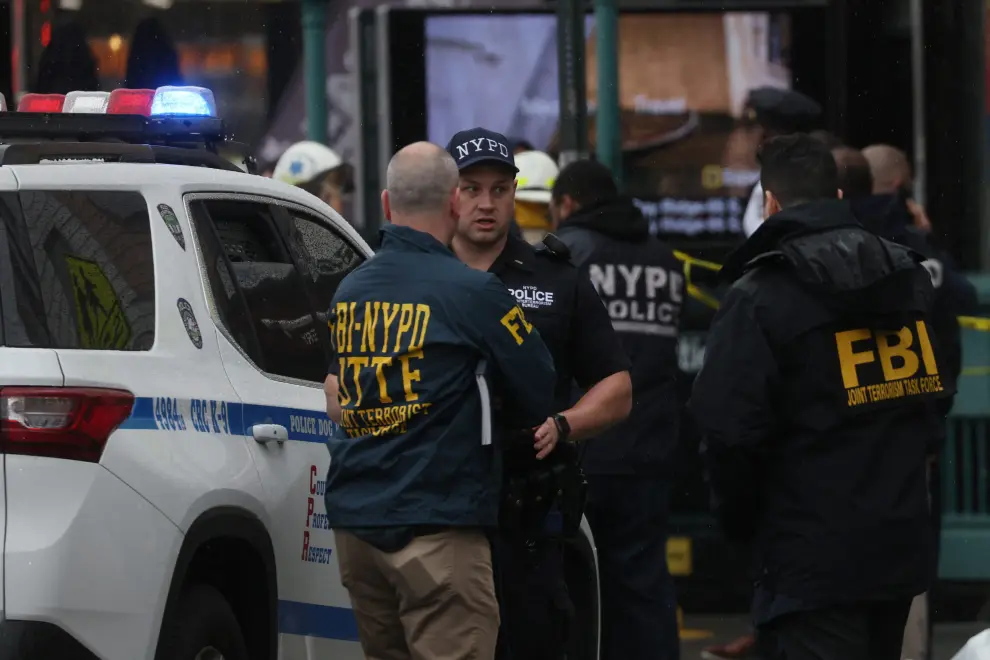 Law enforcement officers work near the scene of a shooting at a subway station in the Brooklyn borough of New York City, New York, U.S., April 12, 2022. REUTERS/Brendan McDermid NEW YORK-SHOOTING/