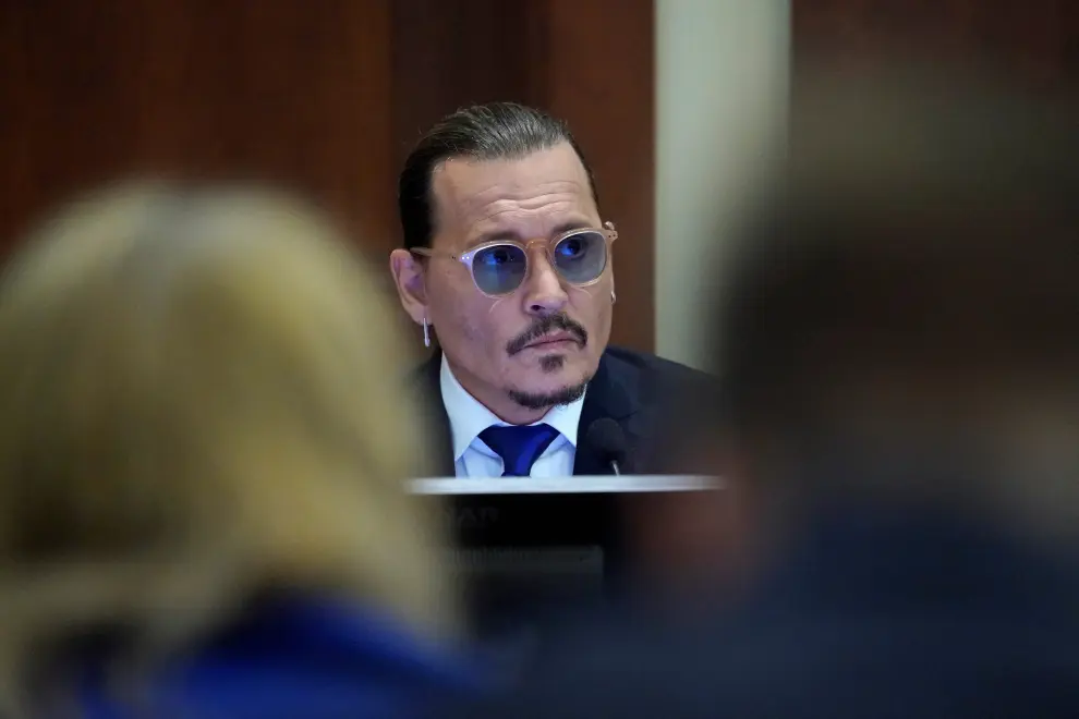 Actor Johnny Depp sits to testify in the courtroom at the Fairfax County Circuit Courthouse in Fairfax, Virginia, U.S., April 25, 2022. Steve Helber/Pool via REUTERS PEOPLE-DEPP/