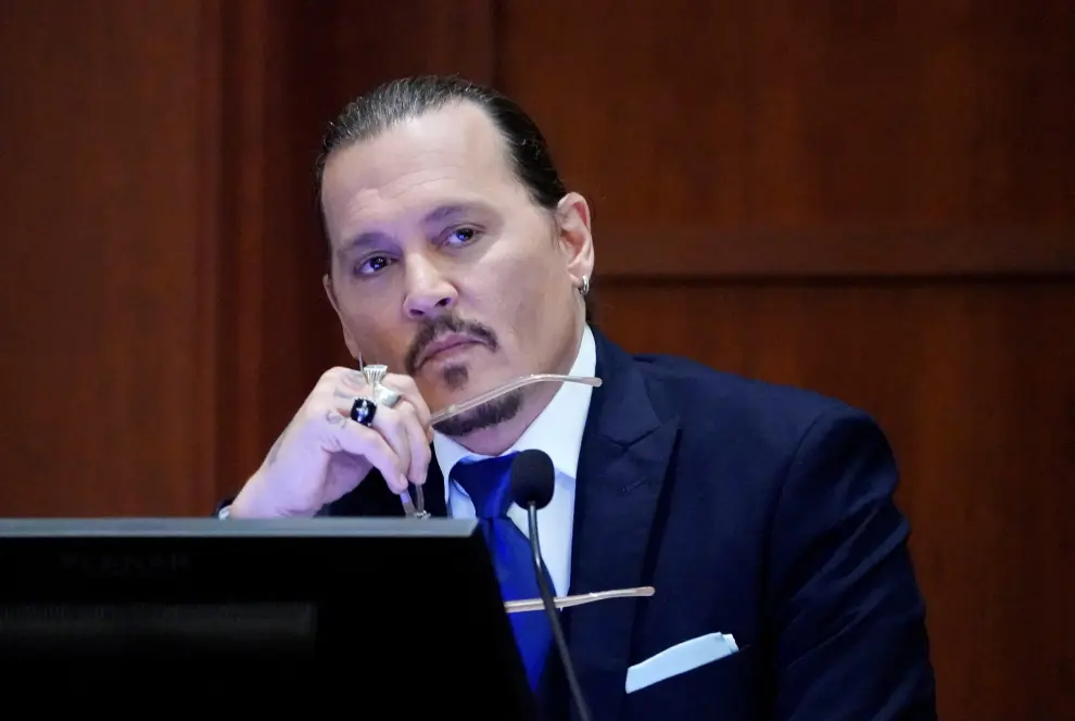 Actor Johnny Depp looks on as he testifies in the courtroom during the defamation trial against ex-wife Amber Heard at the Fairfax County Circuit Courthouse in Fairfax, Virginia, U.S., April 25, 2022. Steve Helber/Pool via REUTERS PEOPLE-DEPP/