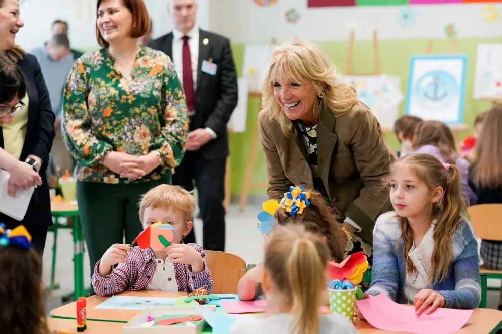U.S. first lady Jill Biden smiles as a little girl gives her paper flowers during her meet with Slovak and Ukrainian mothers and their children as the families participate in a Mother's Day activity, amid Russia's invasion of Ukraine, in Kosice, Slovakia, May 8, 2022. Susan Walsh/Pool via REUTERS UKRAINE-CRISIS/JILL BIDEN