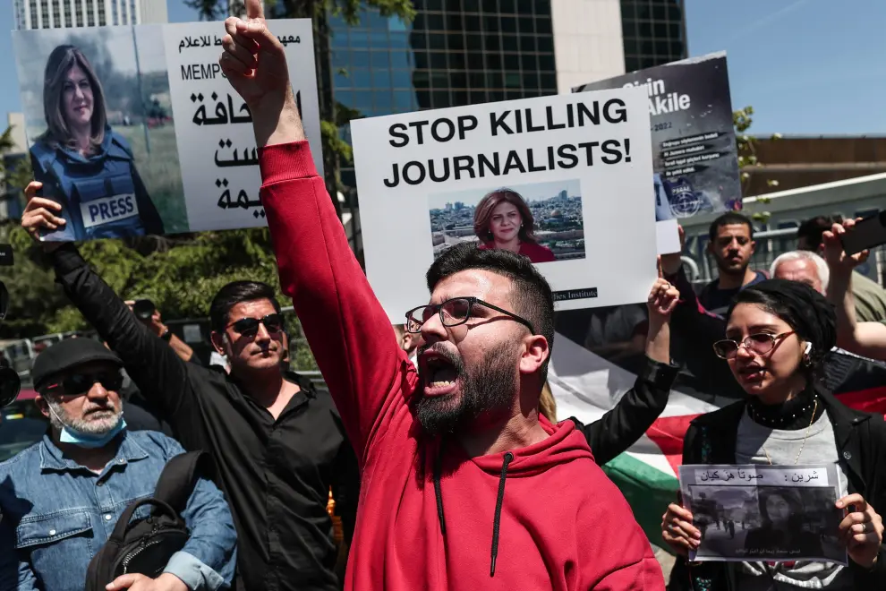 A protester carries a picture of Al Jazeera reporter Shireen Abu Akleh, who was killed during an Israeli raid in Jenin in the occupied West Bank, during a march rally against military rule following a coup in Khartoum, Sudan May 12, 2022. REUTERS/Mohamed Nureldin Abdallah SUDAN-POLITICS/
