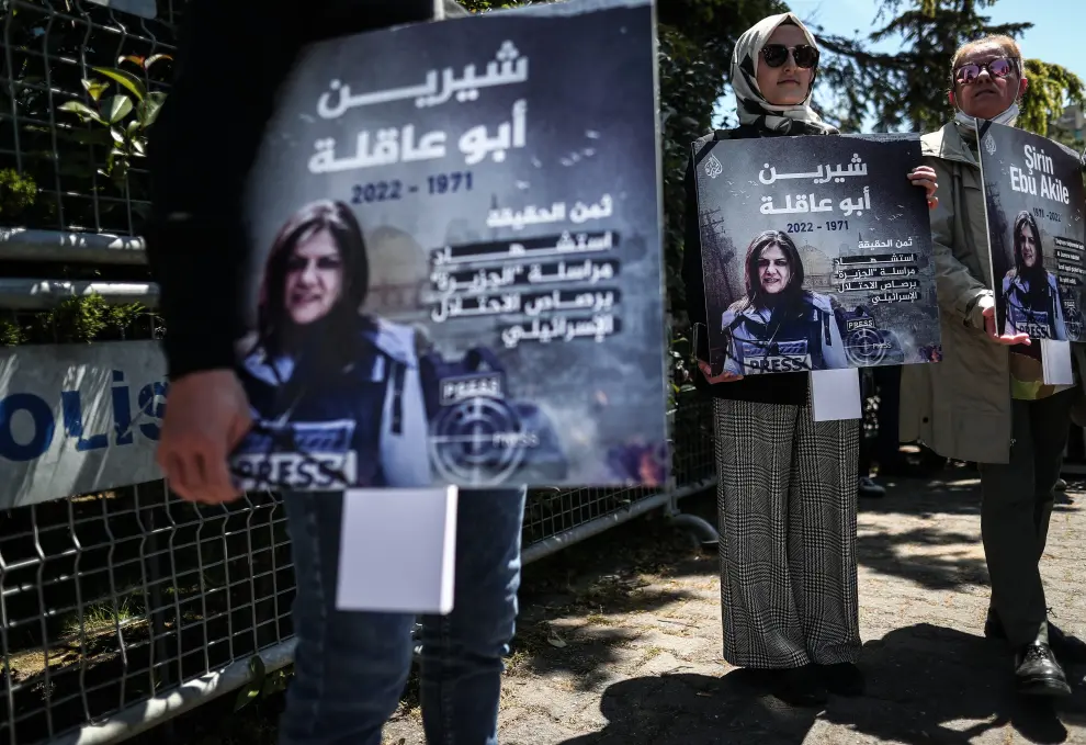 A protester carries a picture of Al Jazeera reporter Shireen Abu Akleh, who was killed during an Israeli raid in Jenin in the occupied West Bank, during a march rally against military rule following a coup in Khartoum, Sudan May 12, 2022. REUTERS/Mohamed Nureldin Abdallah SUDAN-POLITICS/