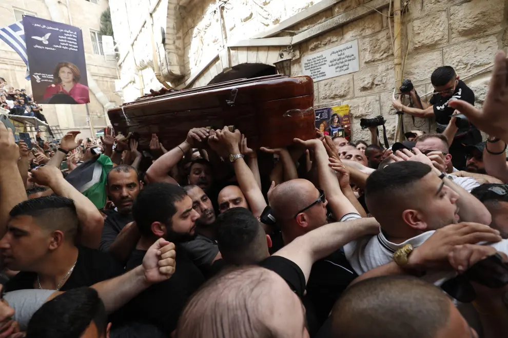Family and friends carry the coffin of Al Jazeera reporter Shireen Abu Akleh, who was killed during an Israeli raid in Jenin in the occupied West Bank, during her funeral in a church in Jerusalem, May 13, 2022. REUTERS/Ammar Awad ISRAEL-PALESTINIANS/JOURNALIST