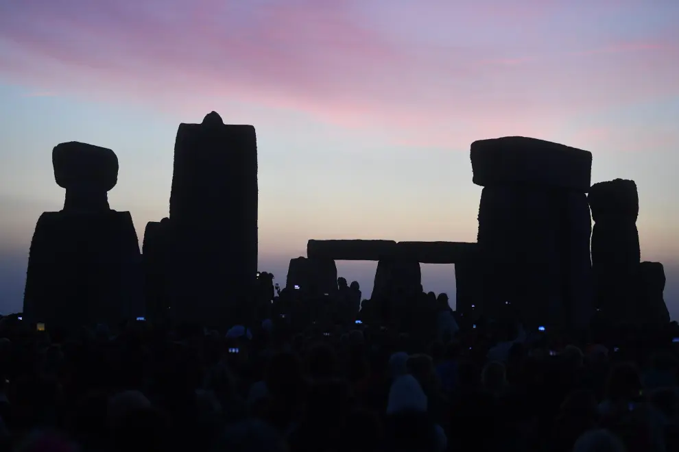 Stonehenge (United Kingdom), 21/06/2022.- The sun rises behind the stones during summer solstice celebrations at the ancient Stonehenge monument in Wiltshire, Britain, 21 June 2022. The annual festival attracts hundreds of people to the 5,000-year-old stone circle to mark the longest day in the northern hemisphere (Reino Unido) EFE/EPA/NEIL HALL
 BRITAIN SOLSTICE STONEHENGE
