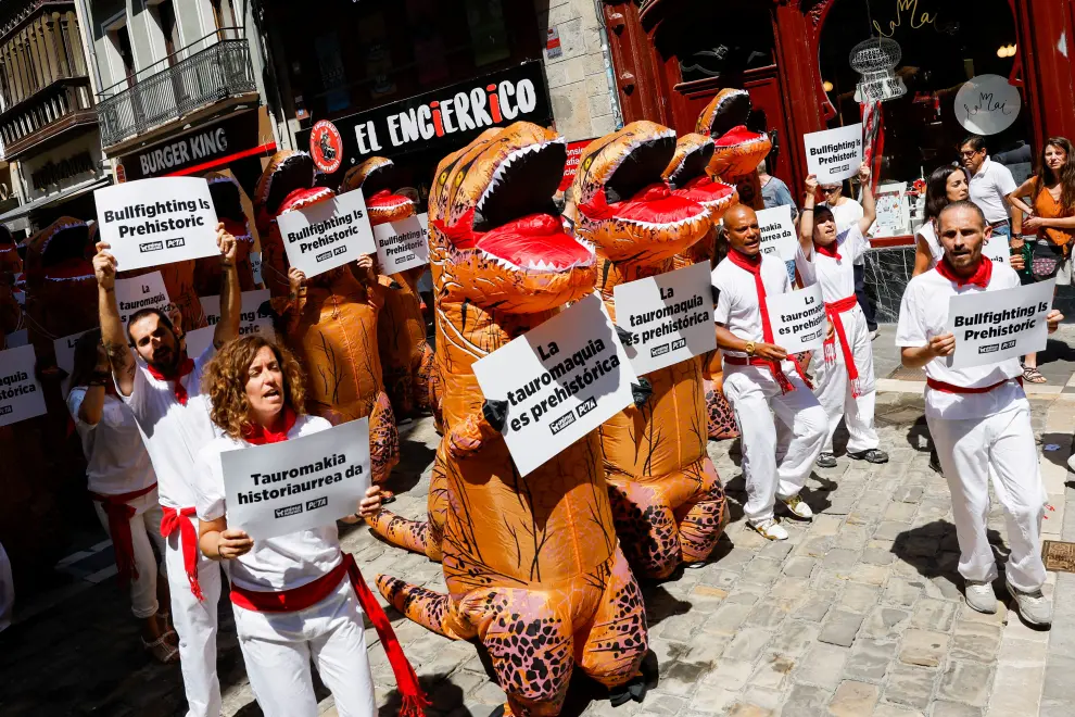 A protester uses a megaphone as activists from the People for the Ethical Treatment of Animals (PETA) and AnimaNaturalis, dressed as dinosaurs, take part in a demonstration against bullfighting a day before the start of the San Fermin festival in Pamplona, Spain, July 5, 2022. REUTERS/Vincent West SPAIN-CULTURE/BULLS