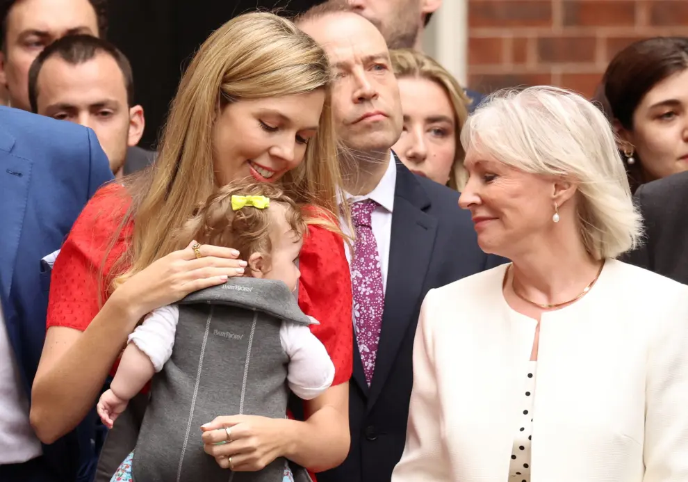 Carrie Johnson with her baby and British Culture Secretary Nadine Dorries stand as British Prime Minister Boris Johnson (not pictured) makes a statement at Downing Street in London, Britain, July 7, 2022. REUTERS/Phil Noble BRITAIN-POLITICS/