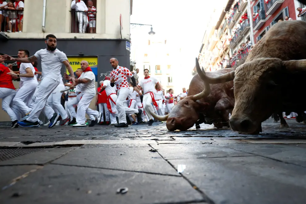 Revellers run during the running of the bulls at the San Fermin festival in Pamplona, Spain, July 7, 2022. REUTERS/Juan Medina SPAIN-CULTURE/BULLS