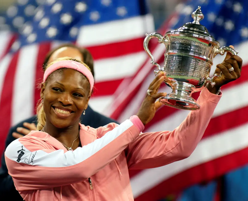 FILE PHOTO: Serena Williams of the U.S. holds her trophy after defeating Venus Williams of the U.S. in their Ladies' Singles finals match at the Wimbledon tennis championships in London, July 4, 2009.   REUTERS/Toby Melville/File Photo TENNIS-USOPEN/SERENA