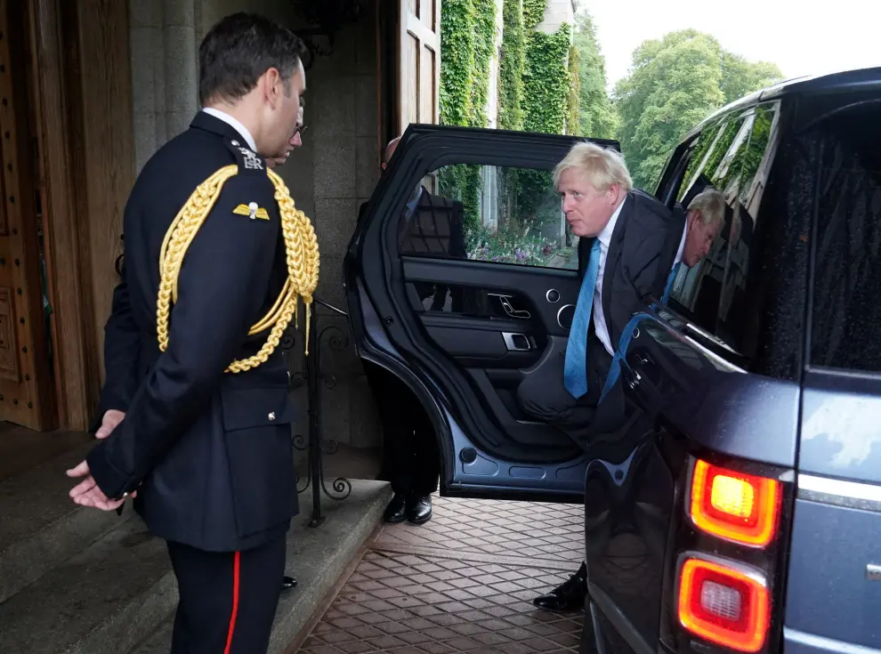 Outgoing Prime Minister Boris Johnson is greeted by the Queen Elizabeth's Equerry Lieutenant Colonel Tom White and her private Secretary Sir Edward Young as he arrives at Balmoral for an audience to formally resign as prime minister, in Britain, September 6, 2022. Andrew Milligan/Pool via REUTERS REFILE - CORRECTING LOCATION BRITAIN-POLITICS/LEADERSHIP