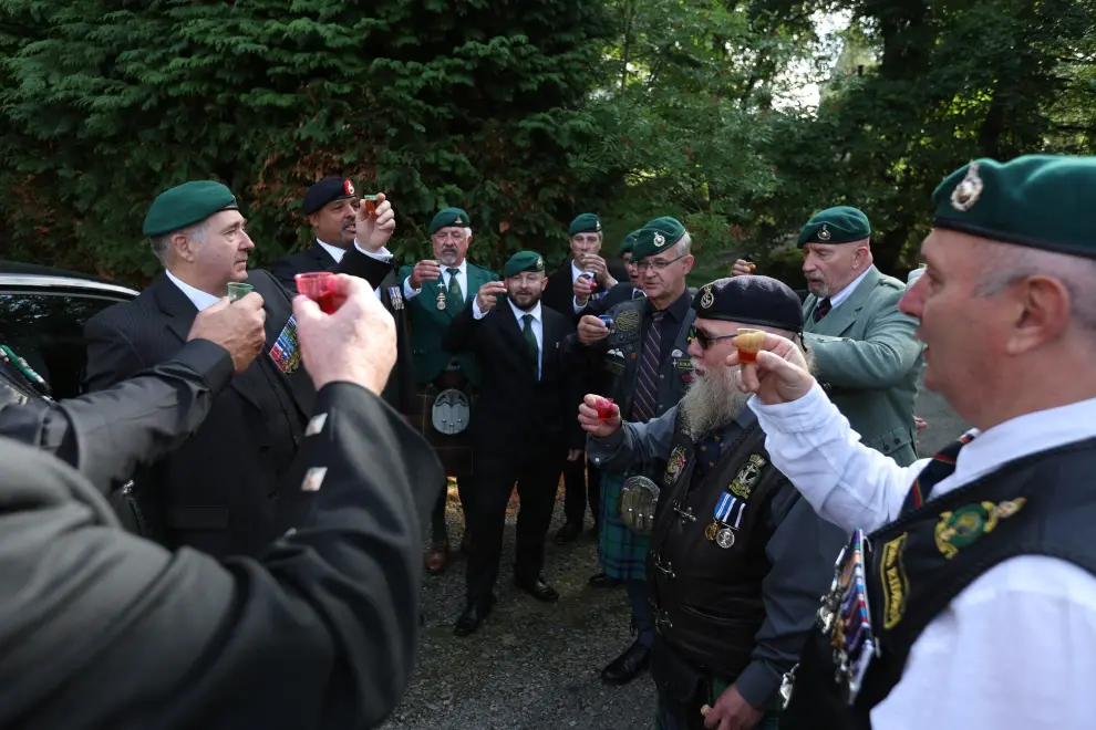 Marines and veterans raise a toast to Britain's Queen Elizabeth following her death, in Balmoral, Scotland, Britain September 11, 2022. REUTERS/Russell Cheyne BRITAIN-ROYALS/QUEEN