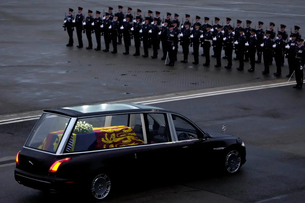 The coffin of Queen Elizabeth II carried in a hearse is leaving RAF Northolt in London, to be taken to Buckingham Palace, Tuesday, Sept. 13, 2022. Kirsty Wigglesworth/Pool via REUTERS BRITAIN-ROYALS/QUEEN
