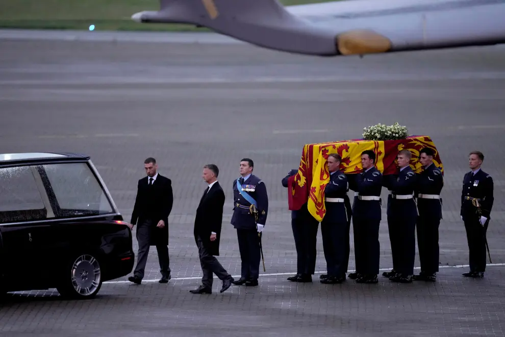 The coffin of Queen Elizabeth II is carried off a plane by the Queen's Colour Squadron and lifted into a hearse at RAF Northolt in London, to be taken to Buckingham Palace, Tuesday, Sept. 13, 2022. Kirsty Wigglesworth/Pool via REUTERS BRITAIN-ROYALS/QUEEN