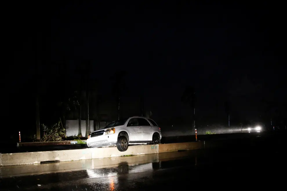 Fallen trees and debris are seen in a parking lot as Hurricane Ian makes landfall in southwestern Florida, in Fort Myers, Florida, U.S. September 28, 2022. REUTERS/Marco Bello  STORM-IAN/FLORIDA